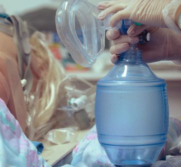 Eine Pflegekraft bereitet ein Beatmungsgerät für eine Patientenversorgung vor.